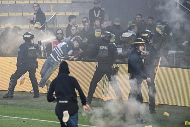 Nantes toulouse match abandoned after pitch invasion and pyrotechnics
