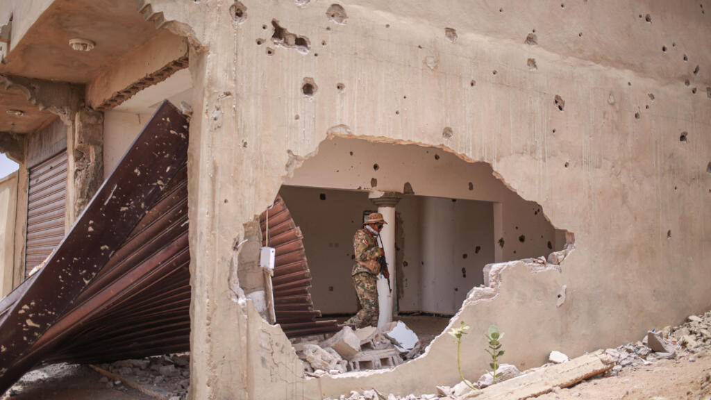 A soldier from the Azawad Liberation Front (FLA) walks inside a damaged building in Kidal on May 9, 2026.