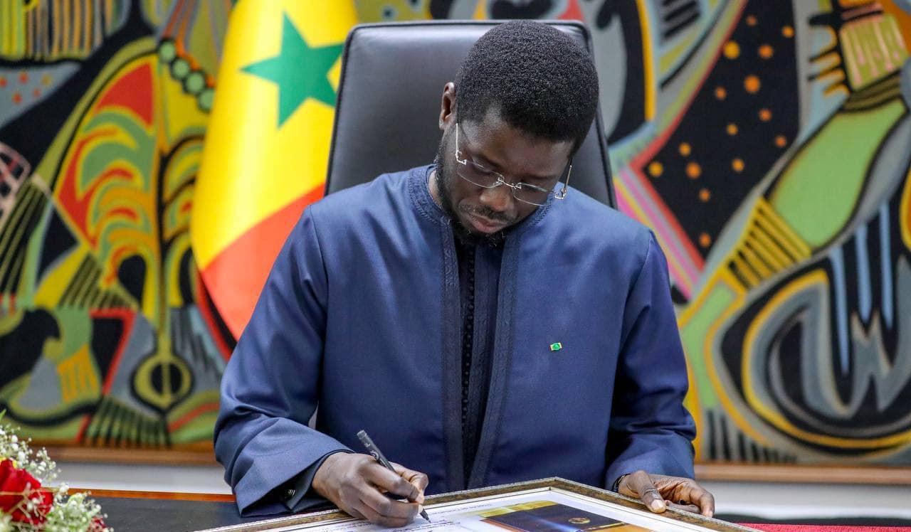 President Bassirou Diomaye Faye signing electoral reform documents