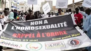 Protesters hold signs reading 'no to homosexuality' during a rally in Dakar calling for criminalization of LGBTQIA+ identities
