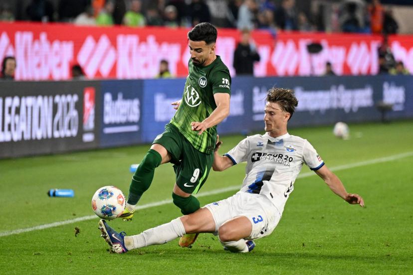 Wolfsburg's Mohamed Amoura battles Paderborn's Jonah Sticker during the first leg of the Bundesliga playoffs. (Teresa Kroeger/Reuters)