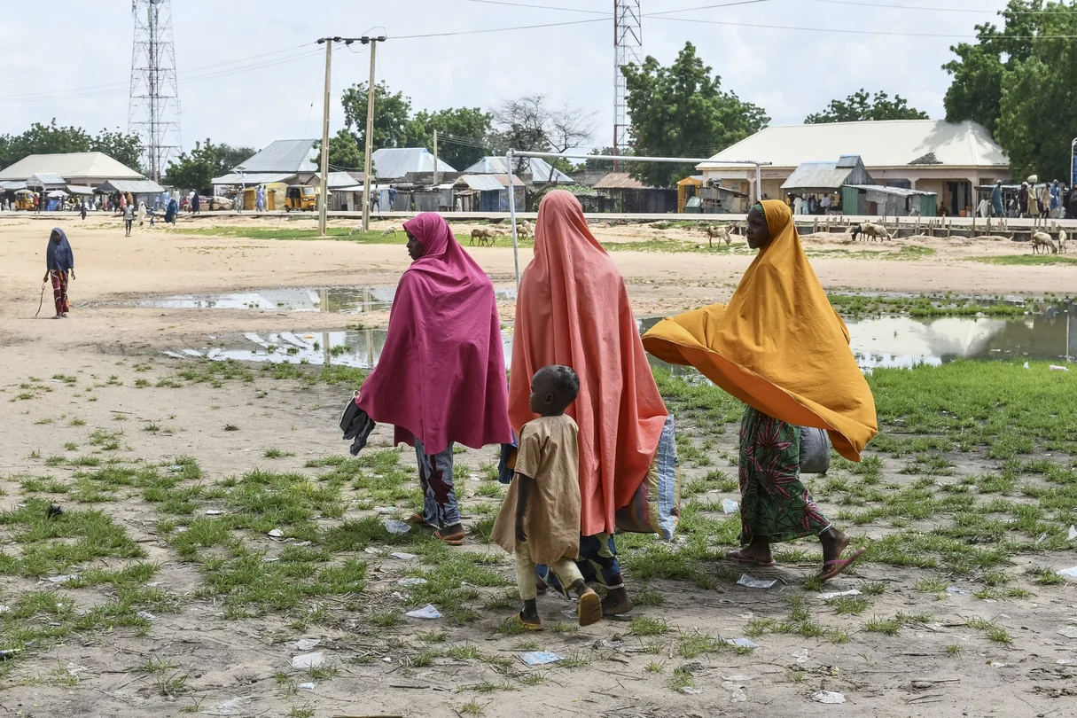 Survivors and relatives of victims of a suspected Boko Haram attack walk in Babban Gide on September 4, 2024. At least 81 people died and several are missing after an attack by suspected Boko Haram jihadists in Yobe State, northeastern Nigeria, local officials confirmed on September 3, 2024. 