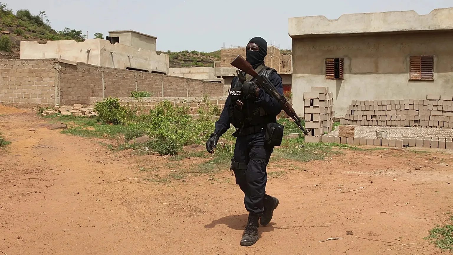 A Malian police officer patrols near Campement Kangaba, a tourist complex outside Bamako, on June 19, 2017
