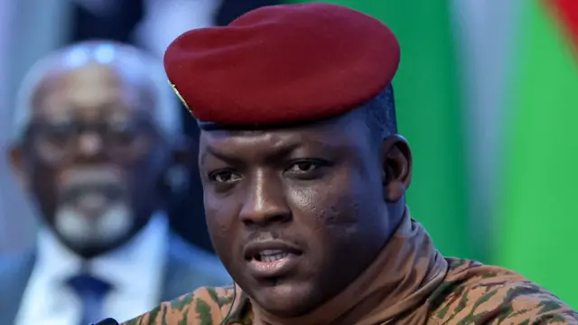 Close-up of Ibrahim Traoré in a beige military uniform and red beret.